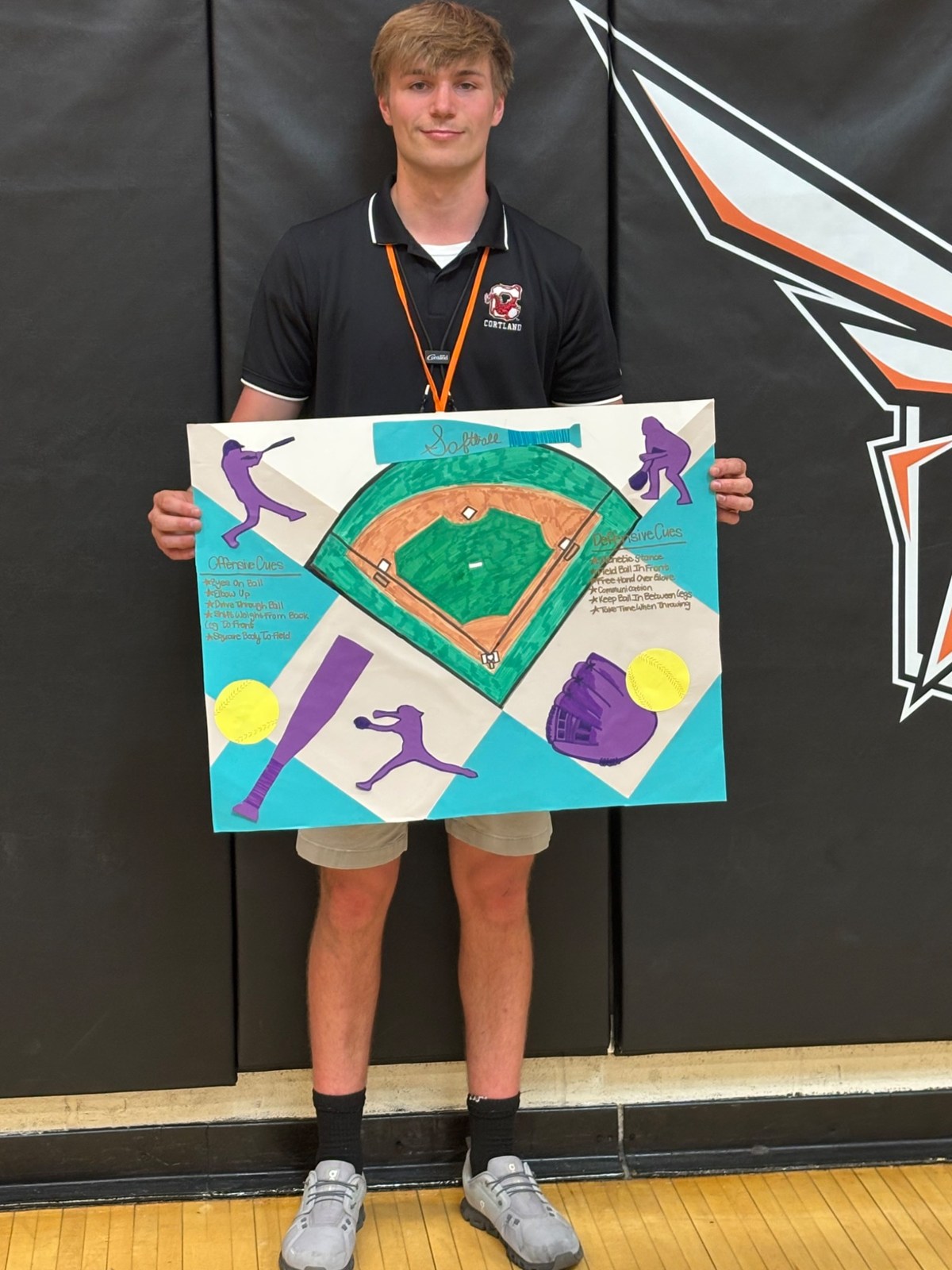 Carter holding a colorful softball teaching visual